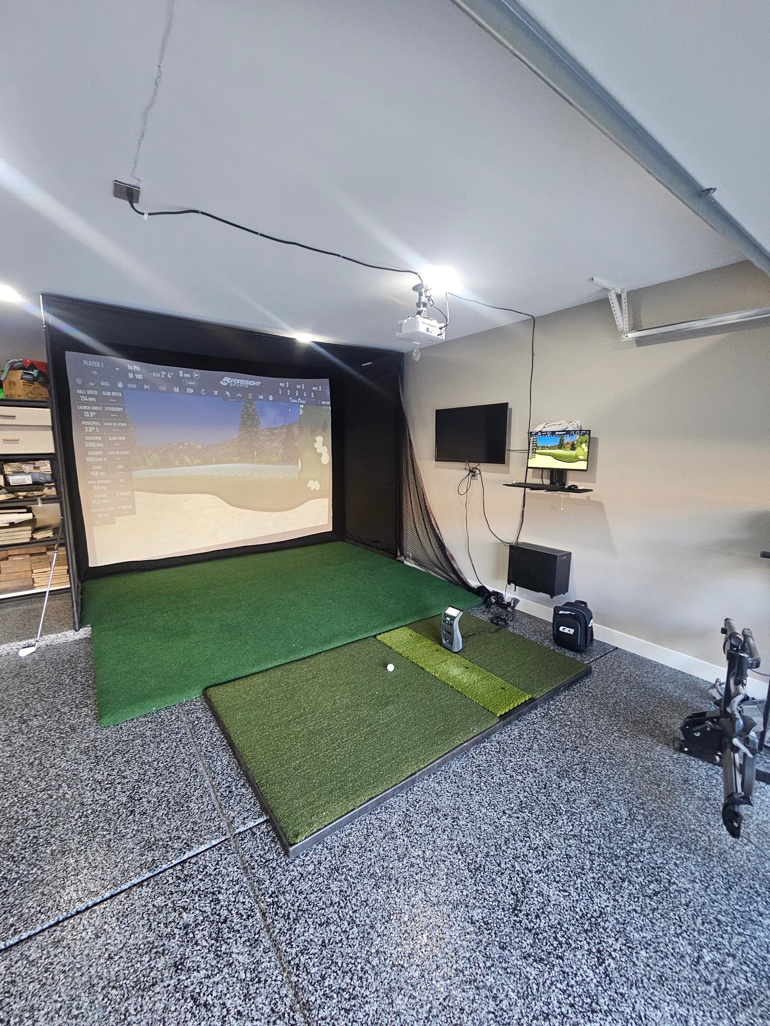 Epoxy flake garage floor with golf simulator in Phoenix Arizona home